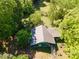 A quaint home from an aerial perspective surrounded by lush trees, providing beauty and privacy at 290 Glenmere Ln, Mooresville, NC 28115