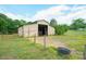 The barn boasts a metal exterior, open front, and fenced area, suitable for various uses at 290 Glenmere Ln, Mooresville, NC 28115