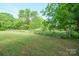 Picturesque grassy land surrounded by mature trees, partially fenced, a lovely pastoral setting at 290 Glenmere Ln, Mooresville, NC 28115