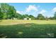 Wide view of expansive, level grassy land with multiple storage buildings at 290 Glenmere Ln, Mooresville, NC 28115