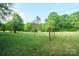 Expansive grassy land, partially fenced with mature trees, ready for your animals at 290 Glenmere Ln, Mooresville, NC 28115