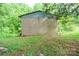 View of back shed with large bay doors surrounded by forest at 290 Glenmere Ln, Mooresville, NC 28115