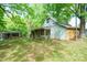 Back exterior shed with a porch, siding, and a green yard under shady trees at 290 Glenmere Ln, Mooresville, NC 28115