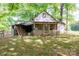 View of back shed with a porch, siding, and a green yard under shady trees at 290 Glenmere Ln, Mooresville, NC 28115