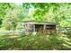 Exterior shot of the shed with a fenced-in area for storage and a grassy yard at 290 Glenmere Ln, Mooresville, NC 28115