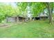 View of the home, shed, and workshop surrounded by shady trees and a green yard at 290 Glenmere Ln, Mooresville, NC 28115