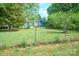 Home surrounded by green grassy yard and a chain-link fence at 290 Glenmere Ln, Mooresville, NC 28115