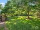 Lush green backyard with mature trees, providing ample shade and privacy at 3068 Streamhaven Dr, Lancaster, SC 29707