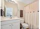 Well-lit bathroom featuring a large mirror, vanity, and shower with patterned curtain at 3068 Streamhaven Dr, Lancaster, SC 29707