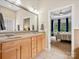 Bathroom featuring a large mirror over a double vanity and access to the main bedroom at 3068 Streamhaven Dr, Lancaster, SC 29707