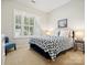 Cozy bedroom featuring a patterned bedspread, a window with shutters, and soft, neutral carpeting at 3068 Streamhaven Dr, Lancaster, SC 29707