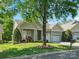 Charming home with a well-manicured lawn, a two-car garage, and beautiful landscaping at 3068 Streamhaven Dr, Lancaster, SC 29707