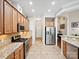 Well-lit kitchen with stainless steel appliances, granite countertops, and wooden cabinets at 3068 Streamhaven Dr, Lancaster, SC 29707