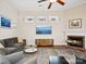 Comfortable living room featuring a fireplace, decorative windows, and a ceiling fan at 3068 Streamhaven Dr, Lancaster, SC 29707
