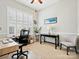 Bright office space featuring multiple desks, a comfortable chair, and a large window for natural light at 3068 Streamhaven Dr, Lancaster, SC 29707