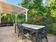 Outdoor patio with a dining table and seating, shaded by a pergola and surrounded by greenery at 3068 Streamhaven Dr, Lancaster, SC 29707