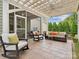 Stylish patio with comfortable seating, overhead lighting, and a beautifully landscaped yard at 3068 Streamhaven Dr, Lancaster, SC 29707