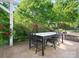 Covered patio with a modern dining set and beautiful roses in the background at 3068 Streamhaven Dr, Lancaster, SC 29707