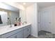 Beautiful bathroom with double sink vanity, large mirror, and gray tile flooring at 316 Gaines Rd, Clover, SC 29710
