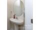 Small bathroom features a pedestal sink, round mirror and neutral decor at 316 Gaines Rd, Clover, SC 29710