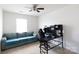 Bright bedroom featuring a ceiling fan, a blue couch and a black computer desk at 316 Gaines Rd, Clover, SC 29710