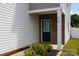 Close-up of the home's entrance featuring a navy blue door, brick accents, and decorative landscaping at 316 Gaines Rd, Clover, SC 29710