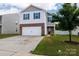 Charming two-story home with a two-car garage, brick accents, and manicured lawn at 316 Gaines Rd, Clover, SC 29710