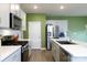 Well-equipped kitchen with stainless steel appliances, sleek countertops, and wood flooring at 316 Gaines Rd, Clover, SC 29710