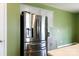 Bright stainless steel refrigerator and white countertops surrounded by green walls and grey cabinets at 316 Gaines Rd, Clover, SC 29710