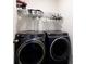 Modern laundry room features front load washer and dryer, and storage shelf with hangers at 316 Gaines Rd, Clover, SC 29710