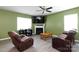 Comfortable living room has a fireplace, ceiling fan, and plush leather seating at 316 Gaines Rd, Clover, SC 29710