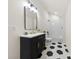 Stylish bathroom featuring a black vanity with gold accents and a shower-over-tub at 317 S Pink St, Cherryville, NC 28021