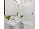 The bathroom features a pedestal sink, decorative mirror, and tile shower with black and white patterned flooring at 317 S Pink St, Cherryville, NC 28021