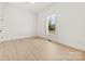 This bedroom features wood-look floors, white walls and trim and a ceiling fan at 317 S Pink St, Cherryville, NC 28021