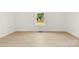 An empty bedroom showcasing wood-look floors, neutral walls, and a window with a neighborhood view at 317 S Pink St, Cherryville, NC 28021