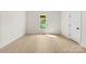 A bedroom with wood-look floors, a single window and light colored walls at 317 S Pink St, Cherryville, NC 28021