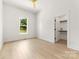 Inviting bedroom with neutral walls, wood-look flooring, a ceiling fan, and closet space at 317 S Pink St, Cherryville, NC 28021