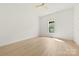 Bright bedroom featuring wood flooring, white walls, and a ceiling fan at 317 S Pink St, Cherryville, NC 28021