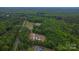 Aerial view of the property with mature trees, including a home and a separate garage/workshop at 332 E Rebound Rd, Lancaster, SC 29720
