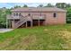 Expansive backyard with a large, multi-level wooden deck perfect for outdoor entertaining at 332 E Rebound Rd, Lancaster, SC 29720