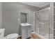 Bathroom with neutral paint, a shower, toilet, and a single sink vanity at 332 E Rebound Rd, Lancaster, SC 29720