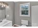 Bathroom featuring white vanity with a modern sink and fixtures, with a window for natural light at 332 E Rebound Rd, Lancaster, SC 29720