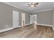 Spacious bedroom with light wood floors, white trim, multiple doors, and a ceiling fan at 332 E Rebound Rd, Lancaster, SC 29720