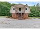 Unique home exterior with a peaked roof and a wooden staircase leading to the entrance at 332 E Rebound Rd, Lancaster, SC 29720