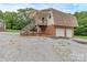 Garage apartment with exterior staircase with two garage doors on the ground floor at 332 E Rebound Rd, Lancaster, SC 29720