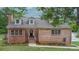 Charming brick home featuring dormer windows, well-maintained landscaping, and inviting front porch at 332 E Rebound Rd, Lancaster, SC 29720