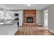 Open kitchen area with brick fireplace, white cabinets, stainless appliances, and an island at 332 E Rebound Rd, Lancaster, SC 29720