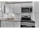 Bright kitchen features stainless steel appliances, white cabinets, granite countertops, and subway tile backsplash at 332 E Rebound Rd, Lancaster, SC 29720