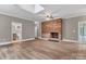 Open living space with a brick fireplace and a sunlit skylight, adjacent to an updated bathroom at 332 E Rebound Rd, Lancaster, SC 29720