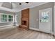 Cozy living room with a brick fireplace, light wood floors, white trim, and a door to the exterior at 332 E Rebound Rd, Lancaster, SC 29720
